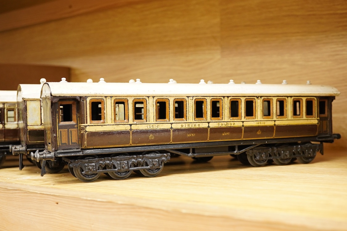 Five 0 gauge tinplate LNWR bogie coaches; four Bing for Bassett-Lowke 1921 series coaches; three Full First corridor coaches, and a Brake Third, together with a Carette 12-wheel Dining Saloon, 13210, all in chocolate and